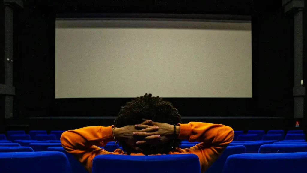 Fan watching a superhero film in cinema